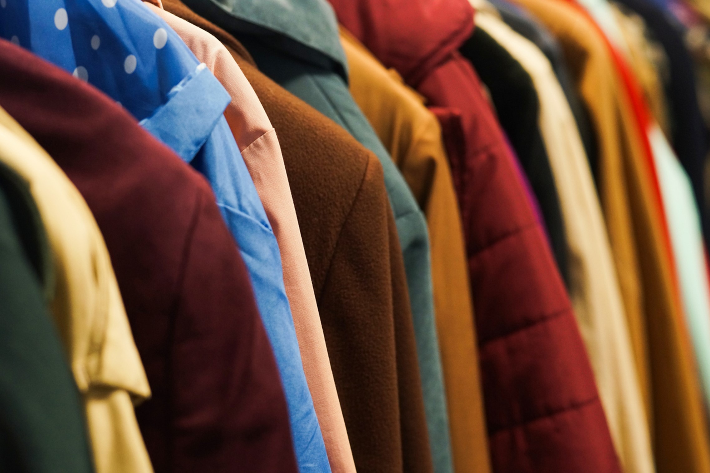 a rack of colourful coats